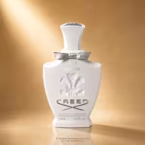 Creed Love in White 100 ML, profumo Creed in flacone bianco con fiocco argentato su sfondo luxury dorato.