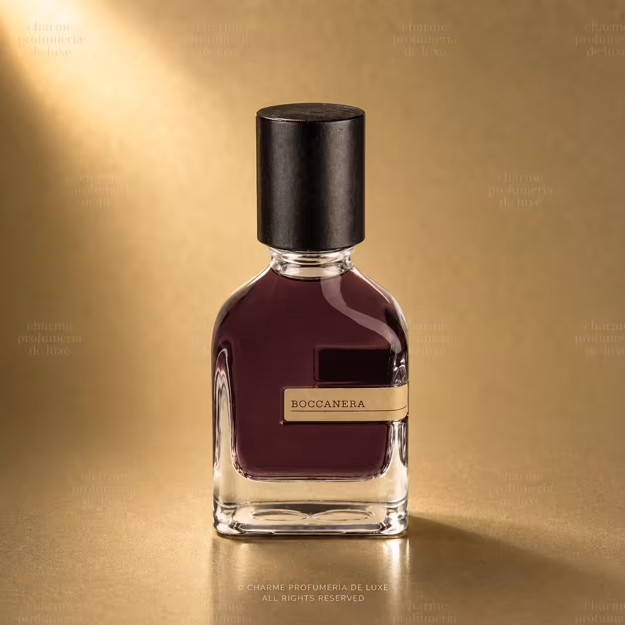 Burgundy perfume bottle with a black cap and gold label reading BOCCANERA, set against a warm gold backdrop