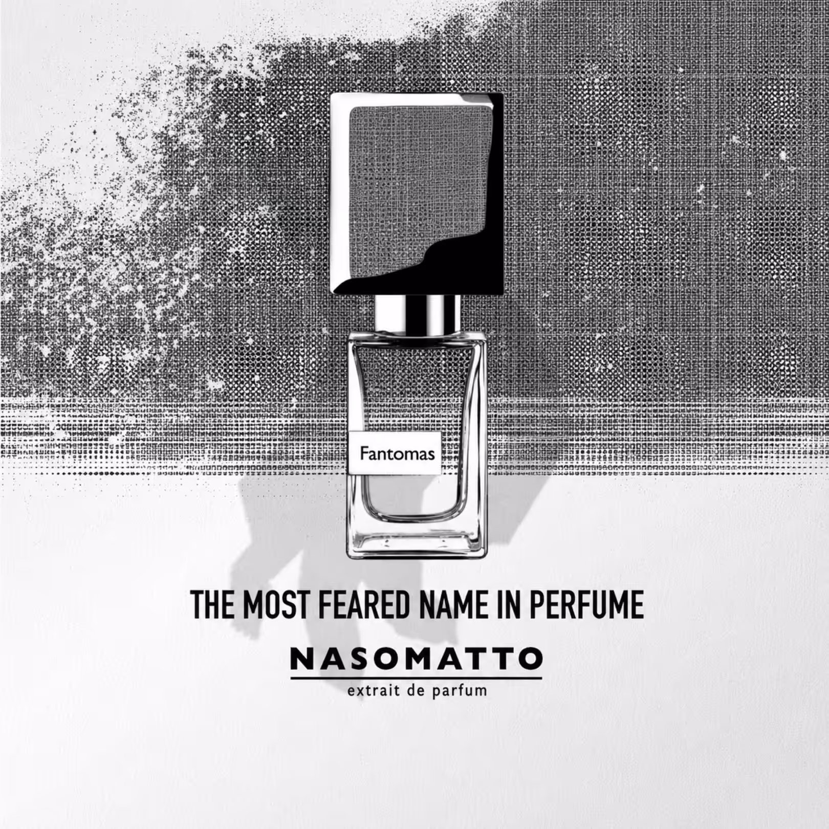 Black-and-white perfume bottle with a square cap and label reading ‘Fantomas’ against a dotted textured background; slogan below reads ‘The most feared name in perfume’ Nasomatto extrait de parfum (advertising image).
