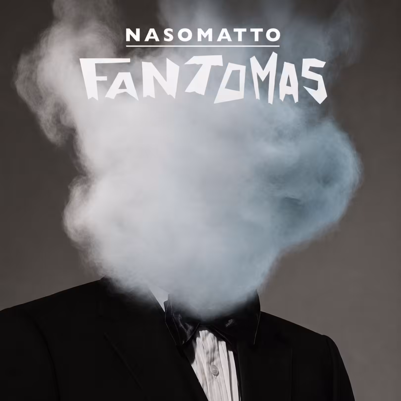 Person in a black suit with head obscured by white smoke, top text reads NASOMATTO FANZOMAS against a dark background.