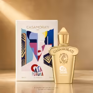 Gold Casamorati perfume bottle with colorful abstract box art beside it on a warm backdrop.