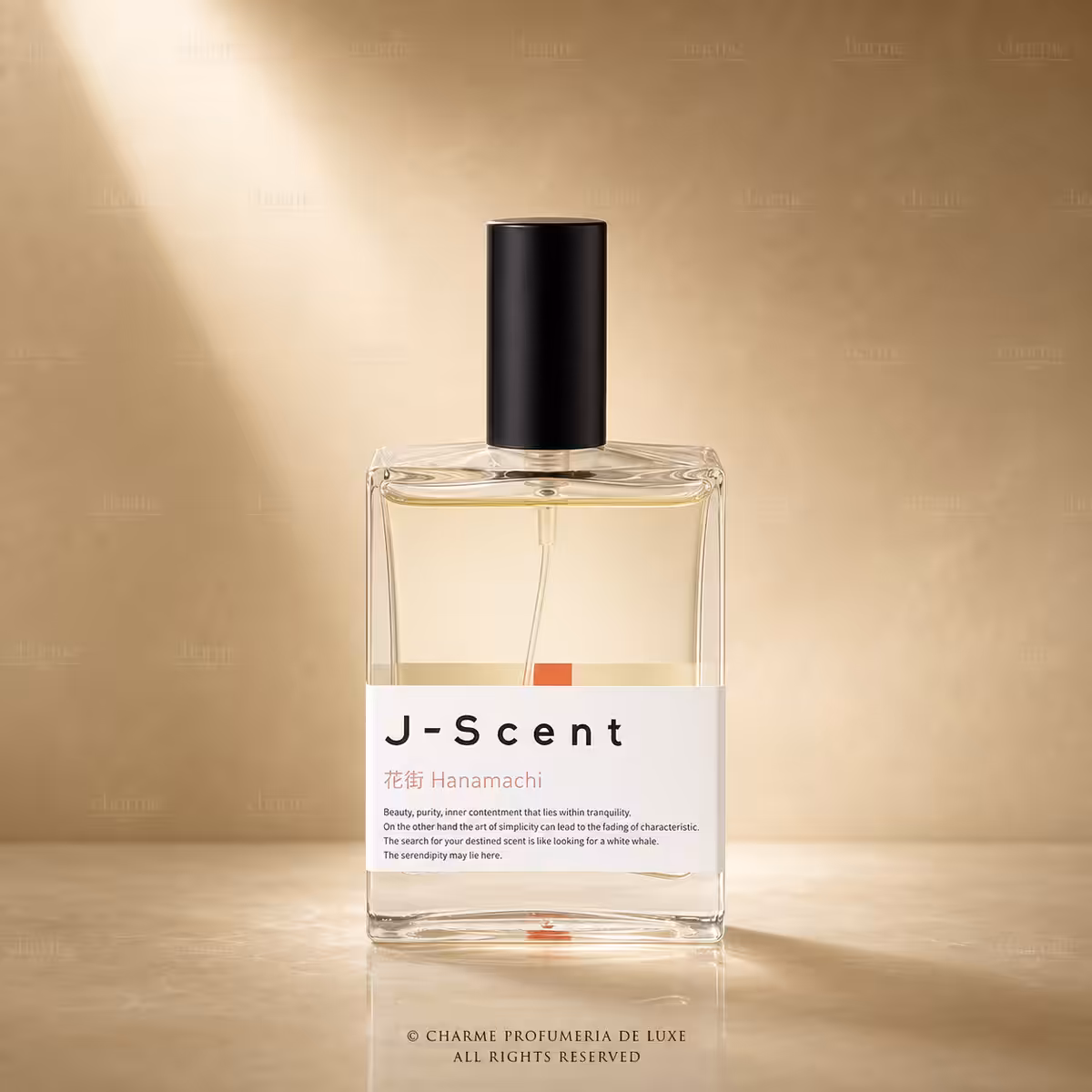 Clear glass perfume bottle with black cap on a warm beige background; label reads 'J-Scent Hanamachi'.