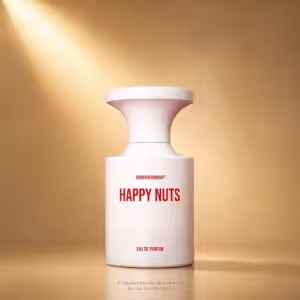 White perfume bottle with a flared cap on a warm gold background, labeled HAPPY NUTS in bold red letters.