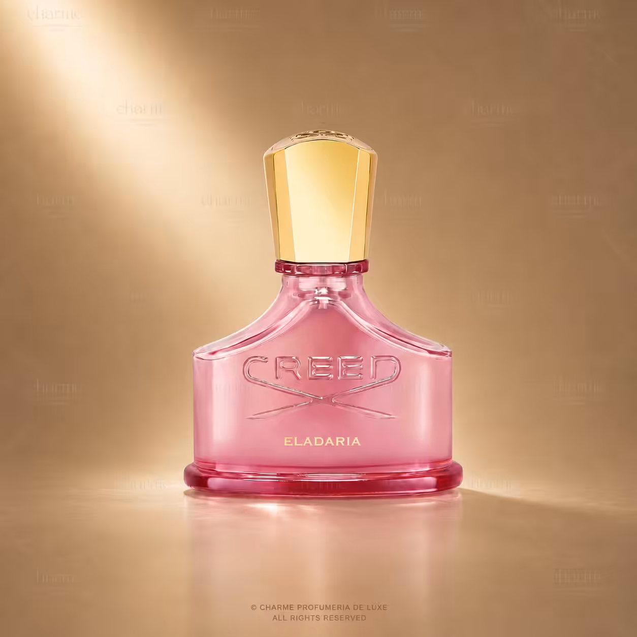 Pink Creed Eladaria perfume bottle with a tall gold cap against a warm gold background, embossed CREED on the bottle.