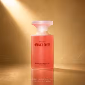 Pink bottle labeled 'Drunk Lovers' hand and body wash with a frosted white cap, set against a warm gold backdrop.