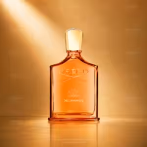 Creed Delphinus profumo unisex, flacone arancione in packshot luxury su sfondo dorato.