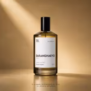 Perfume bottle with white label reading SARANGHAEYO, '70.' and 'BASTING DAY' on a warm gold background.